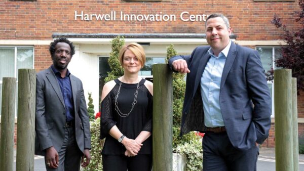 Flashback to 2005: Planet IT co-founders Gavin Jones (pictured left) and Sean Smith (pictured right) are welcomed by Jo Stevens (centre) of Oxford Innovation Space as they move into their first office at Harwell Innovation Centre in 2005 — the launchpad for what would become an incredible business journey.